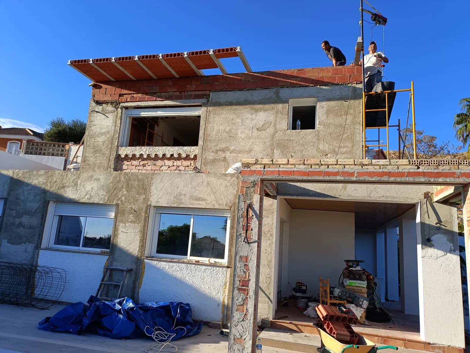 Solteana's crew raising the upper floor and roof of a house